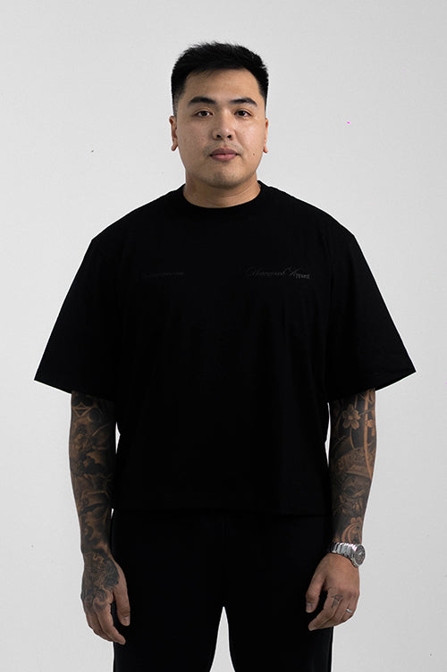 UA Cursive FCO Black tee on model editorial