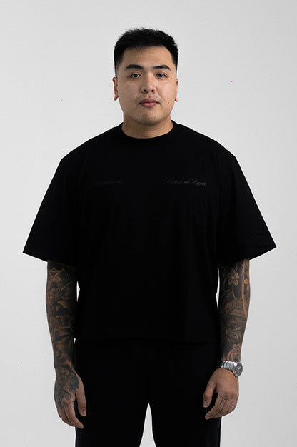 UA Cursive FCO Black tee on model editorial